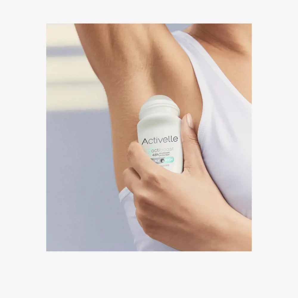 Oriflame Activelle Invisible Fresh deodorant roll-on being applied to underarm for long-lasting freshness